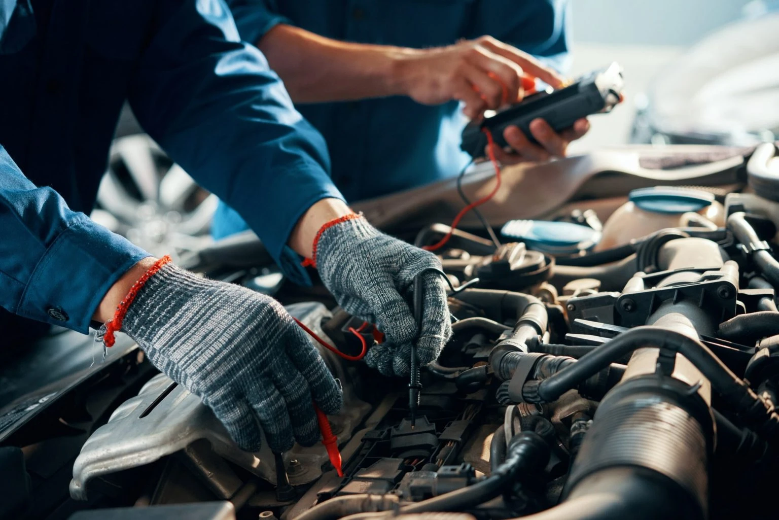 Automobiļu servisa darbnīca ar meistaru un automašīnu uz pacēlāja